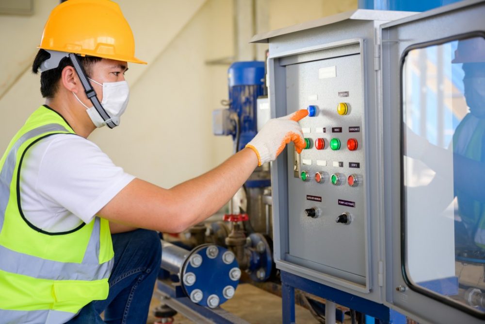 Young electrical engineer wearing a mask Inspect the electrical